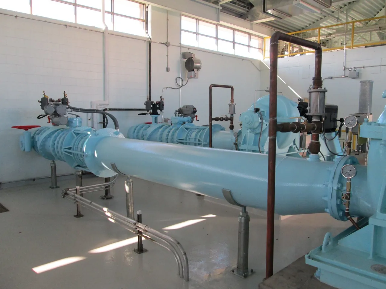 A large room with pipes and valves in it.